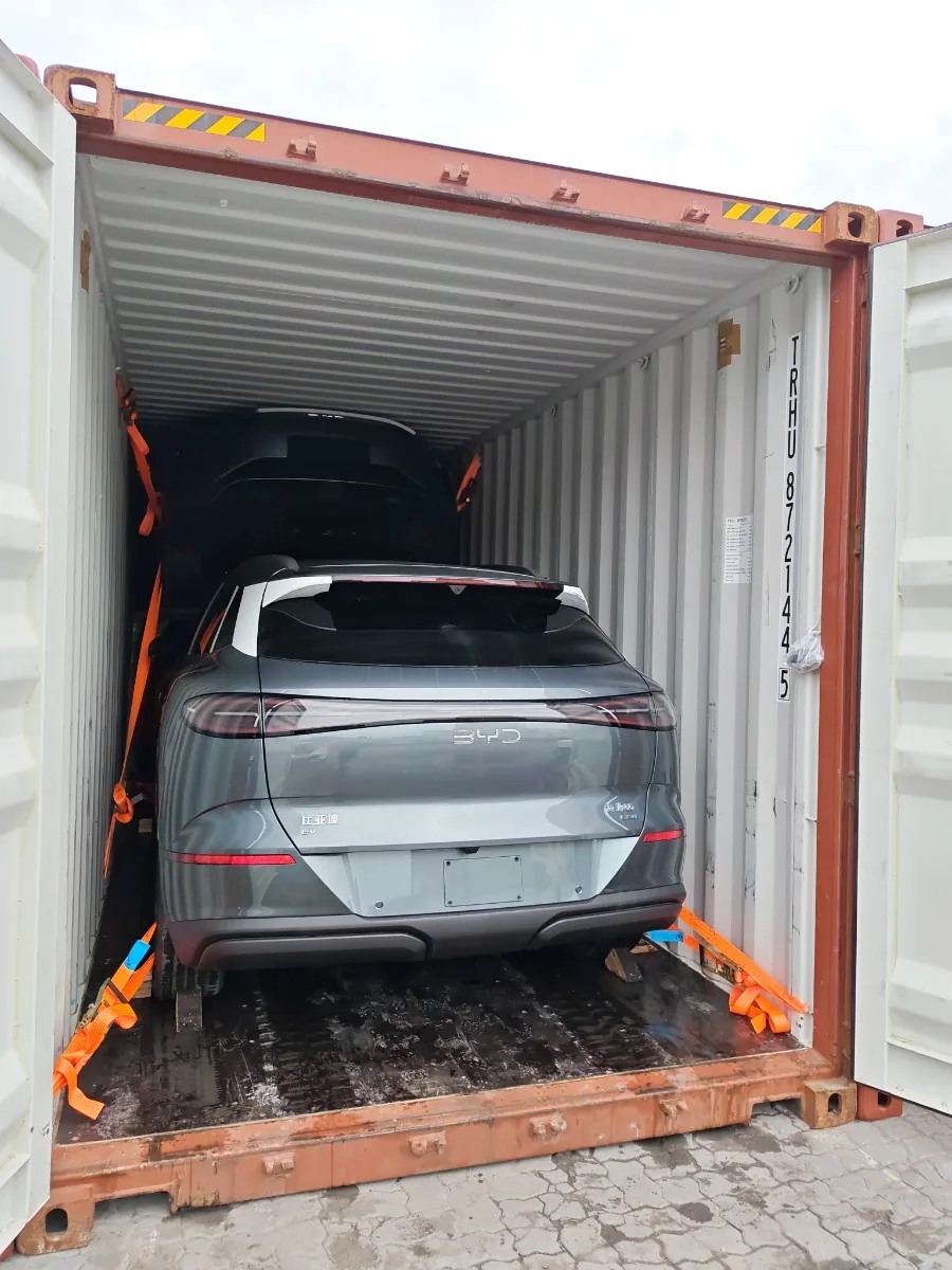 Open shipping container with a vehicle ready for export